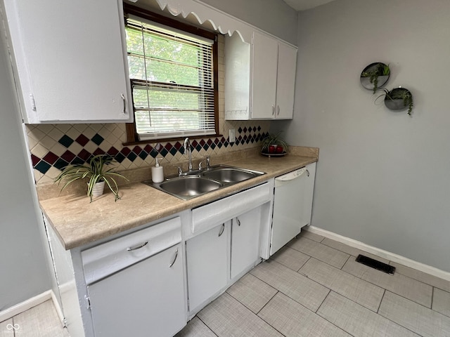 1726 N Linwood Ave, Indianapolis, IN 46218 - kitchen featuring dishwasher, white cabinets, light countertops, and decorative backsplash