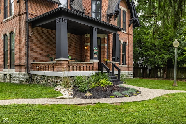 5631 University Ave, Indianapolis, IN 46219 - view of exterior entry featuring brick siding and a porch
