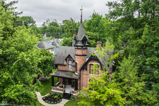 5631 University Ave, Indianapolis, IN 46219 - rear view of property with a porch, a chimney, brick siding, and a shingled roof