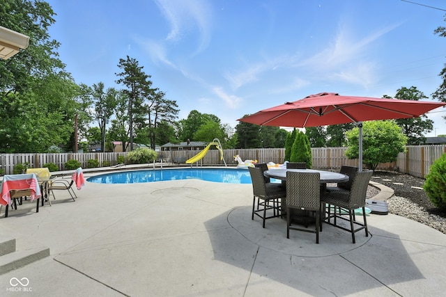 3191 W 246th St, Sheridan, IN 46069 - view of swimming pool with a water slide, a playground, a patio area, outdoor dining space, and a fenced backyard