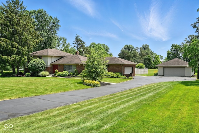 3191 W 246th St, Sheridan, IN 46069 - ranch-style house with brick siding, a detached garage, a front yard, and a chimney