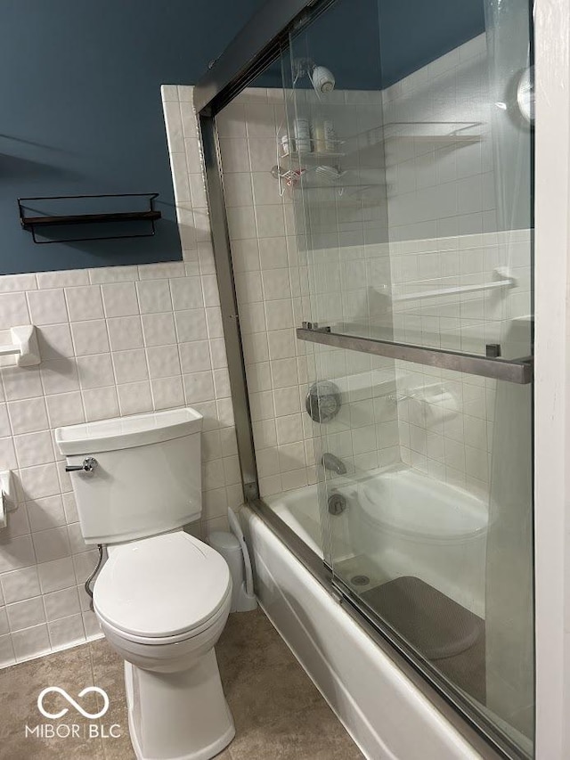 4728 S Eaton Ave, Indianapolis, IN 46239 - bathroom with combined bath / shower with glass door, tile walls, and tile patterned flooring