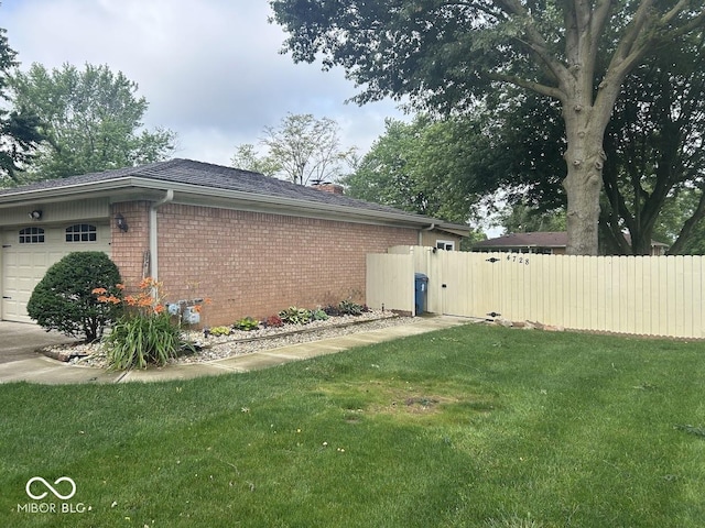4728 S Eaton Ave, Indianapolis, IN 46239 - view of side of home with a garage, brick siding, and a chimney