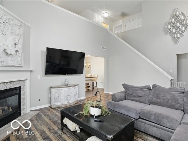 8508 Aviva Ln, Indianapolis, IN 46237 - living area with wood finished floors, stairs, and a tile fireplace