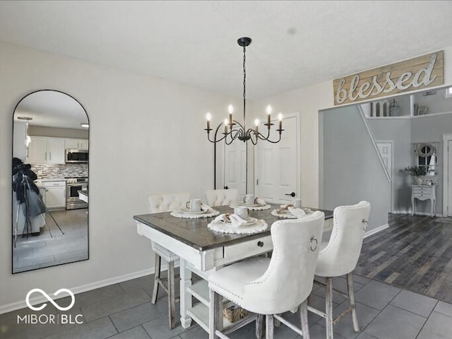 8508 Aviva Ln, Indianapolis, IN 46237 - dining room with dark tile patterned floors and a chandelier