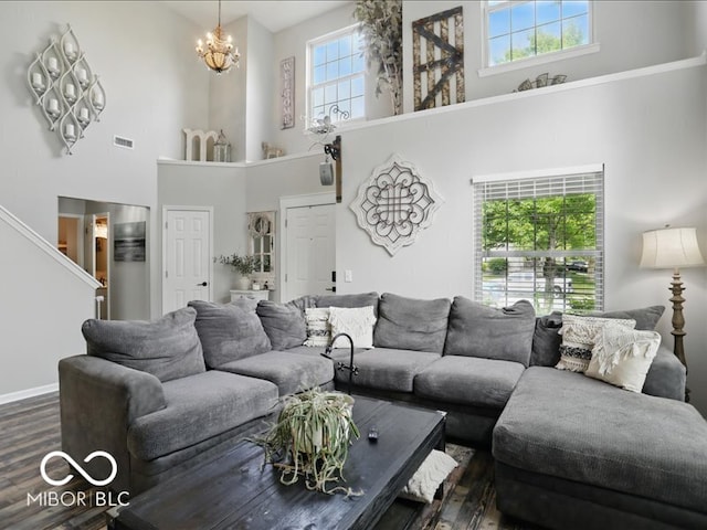8508 Aviva Ln, Indianapolis, IN 46237 - living room featuring a towering ceiling, dark wood-style floors, a chandelier, and stairway
