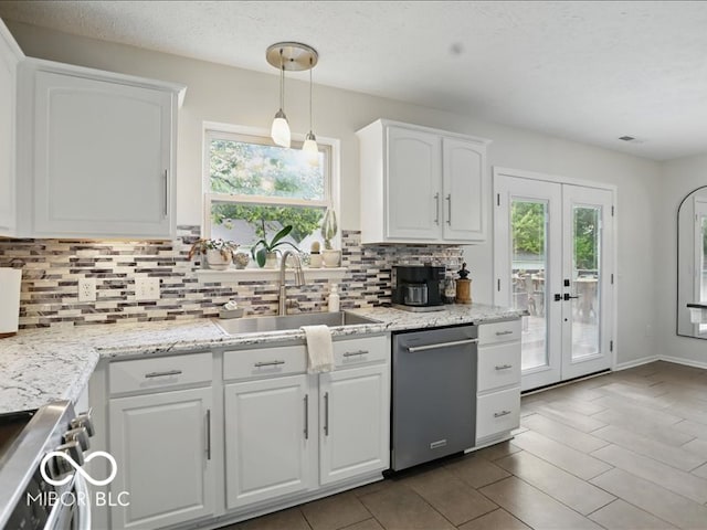 8508 Aviva Ln, Indianapolis, IN 46237 - kitchen featuring stainless steel appliances, decorative backsplash, white cabinets, french doors, and decorative light fixtures