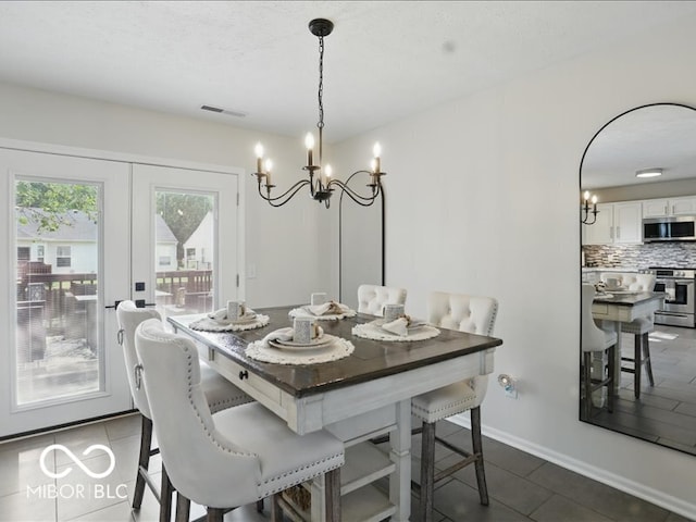 8508 Aviva Ln, Indianapolis, IN 46237 - dining space featuring a chandelier and dark tile patterned flooring