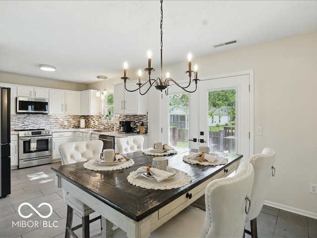 8508 Aviva Ln, Indianapolis, IN 46237 - dining space featuring a chandelier and light tile patterned flooring
