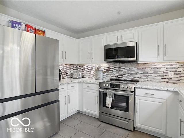 8508 Aviva Ln, Indianapolis, IN 46237 - kitchen with appliances with stainless steel finishes, light tile patterned floors, and white cabinetry