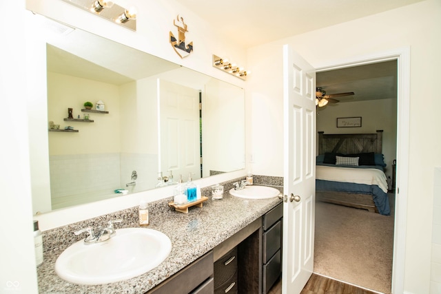 108 Herbert Ct, Trafalgar, IN 46181 - bathroom featuring ensuite bath, double vanity, ceiling fan, and wood finished floors