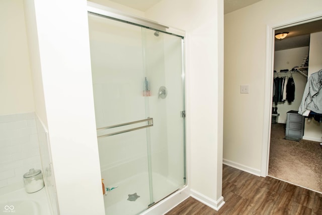 108 Herbert Ct, Trafalgar, IN 46181 - full bath featuring a shower stall, a spacious closet, and wood finished floors