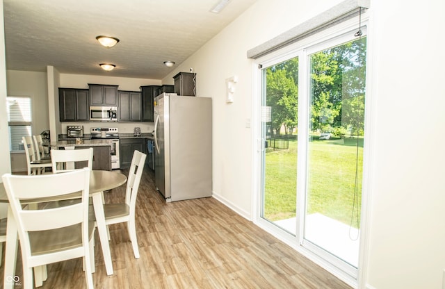 108 Herbert Ct, Trafalgar, IN 46181 - dining area with light wood-style flooring and a textured ceiling