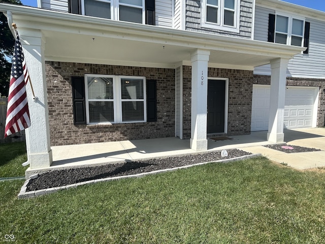 108 Herbert Ct, Trafalgar, IN 46181 - property entrance featuring brick siding, a porch, a garage, and a lawn