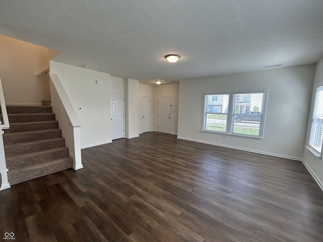 108 Herbert Ct, Trafalgar, IN 46181 - unfurnished living room featuring dark wood finished floors, stairs, and a textured ceiling