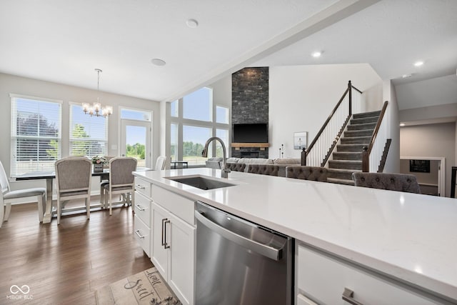 6330 Teakwood Way, Mccordsville, IN 46055 - kitchen with stainless steel dishwasher, a chandelier, lofted ceiling, white cabinets, and light countertops