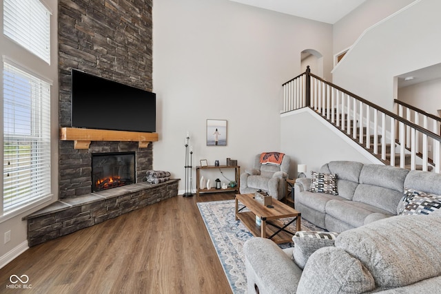 6330 Teakwood Way, Mccordsville, IN 46055 - living area featuring a high ceiling, a stone fireplace, wood finished floors, and stairway