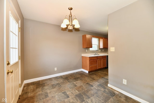 915 E Drybread Ln, Nineveh, IN 46164 - kitchen with a chandelier, light countertops, hanging light fixtures, brown cabinets, and dark stone finish flooring