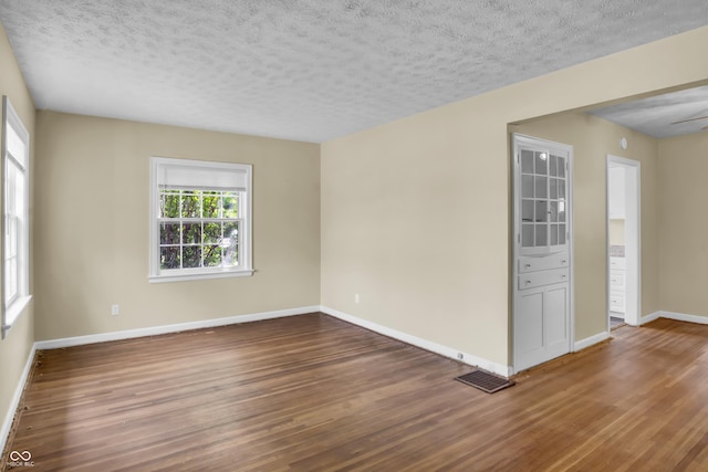 2433 17th St, Columbus, IN 47201 - spare room featuring wood finished floors and a textured ceiling