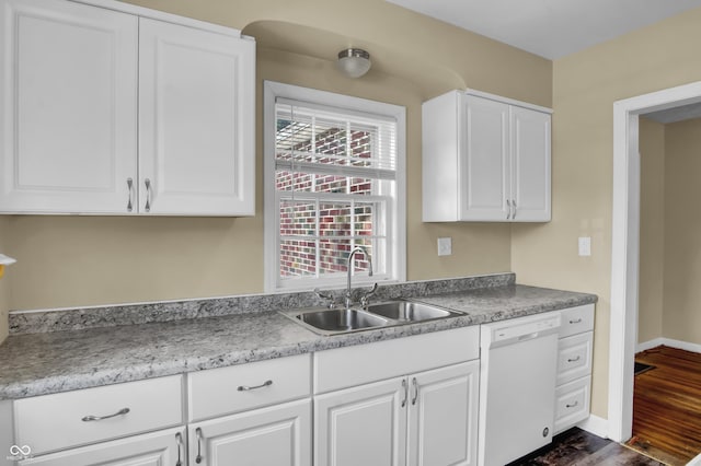 2433 17th St, Columbus, IN 47201 - kitchen with white dishwasher, dark wood-style floors, white cabinets, and light countertops
