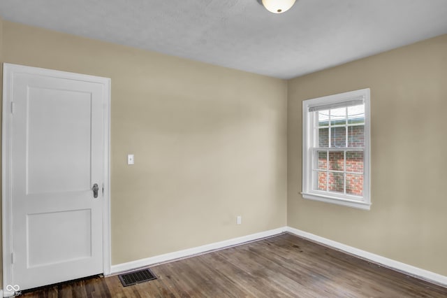 2433 17th St, Columbus, IN 47201 - empty room with baseboards and dark wood-type flooring