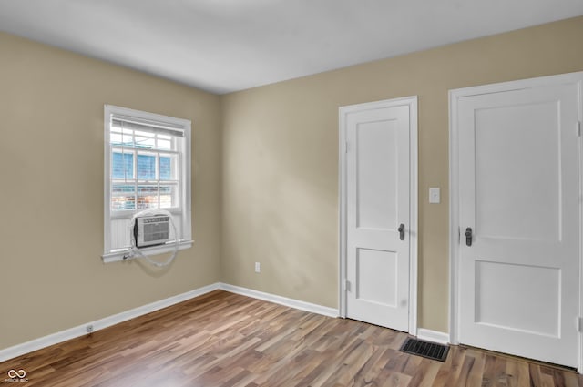 2433 17th St, Columbus, IN 47201 - unfurnished bedroom with wood finished floors and baseboards