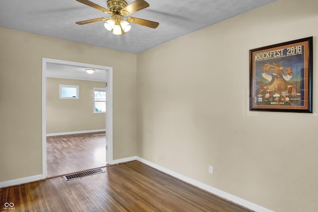 2433 17th St, Columbus, IN 47201 - empty room with hardwood / wood-style floors and a ceiling fan