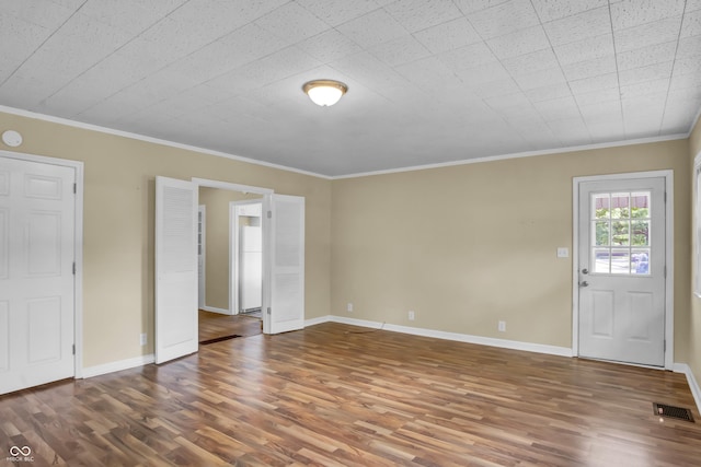 2433 17th St, Columbus, IN 47201 - spare room featuring wood finished floors and ornamental molding