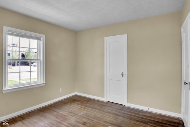 2433 17th St, Columbus, IN 47201 - empty room featuring baseboards and wood finished floors