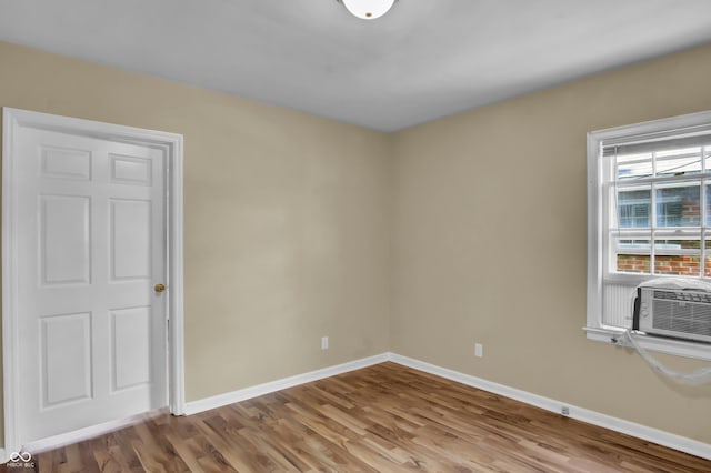 2433 17th St, Columbus, IN 47201 - empty room with wood finished floors and cooling unit