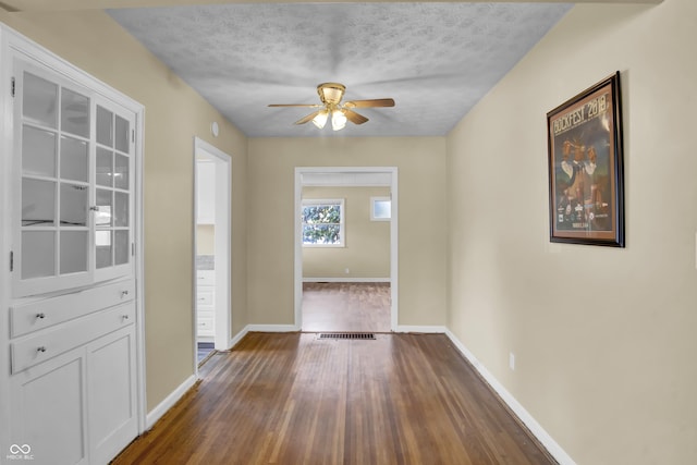 2433 17th St, Columbus, IN 47201 - hall with dark wood-type flooring and a textured ceiling