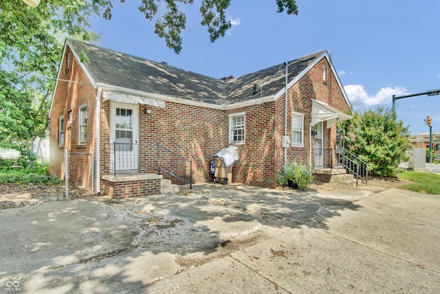 2433 17th St, Columbus, IN 47201 - view of front facade with brick siding, roof with shingles, and concrete driveway