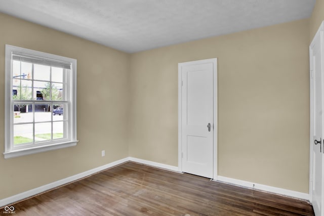 2433 17th St, Columbus, IN 47201 - empty room with baseboards and wood finished floors