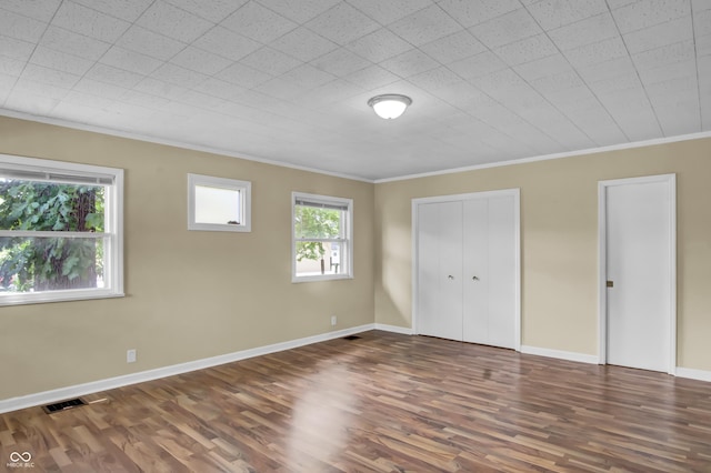 2433 17th St, Columbus, IN 47201 - unfurnished bedroom with ornamental molding and wood finished floors