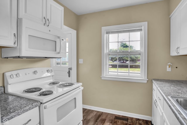 2433 17th St, Columbus, IN 47201 - kitchen featuring white appliances, white cabinetry, light countertops, and dark wood-style flooring