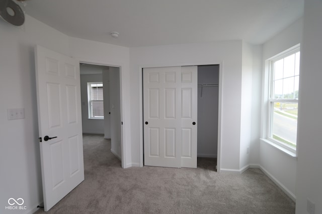 1825 Real St, Indianapolis, IN 46240 - unfurnished bedroom with carpet, multiple windows, and a closet