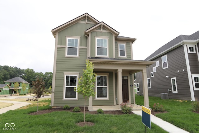 1825 Real St, Indianapolis, IN 46240 - view of front of home with covered porch, board and batten siding, and a front yard