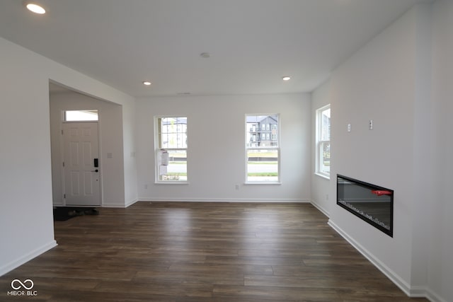 1825 Real St, Indianapolis, IN 46240 - unfurnished living room with recessed lighting, dark wood-type flooring, and a glass covered fireplace