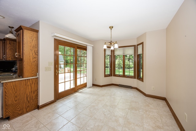 1112 N Dogwood Way, Greenfield, IN 46140 - unfurnished dining area with healthy amount of natural light, a chandelier, and light tile patterned floors