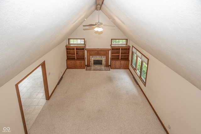 1112 N Dogwood Way, Greenfield, IN 46140 - unfurnished living room featuring lofted ceiling, a textured ceiling, a ceiling fan, light colored carpet, and a brick fireplace