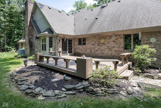 1112 N Dogwood Way, Greenfield, IN 46140 - rear view of house featuring a chimney, a wooden deck, brick siding, and roof with shingles