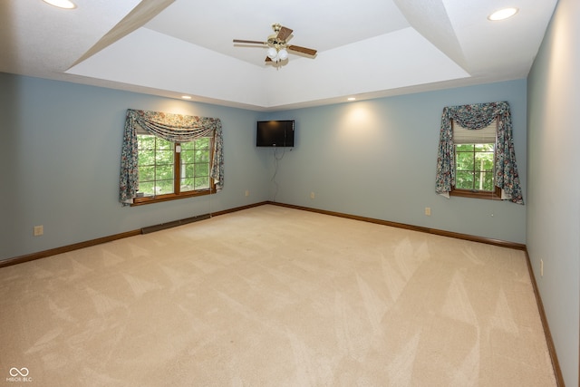 1112 N Dogwood Way, Greenfield, IN 46140 - unfurnished room featuring plenty of natural light, a tray ceiling, light carpet, and recessed lighting