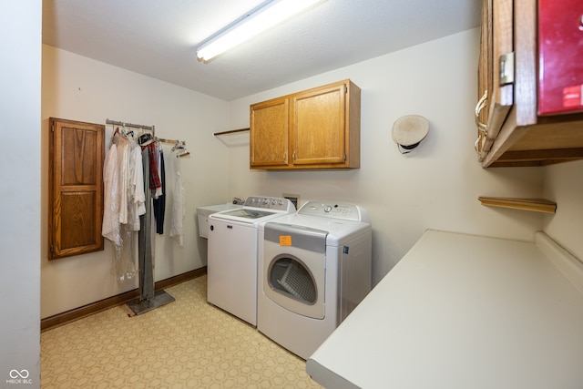 1112 N Dogwood Way, Greenfield, IN 46140 - laundry room featuring cabinet space, washing machine and clothes dryer, and light floors