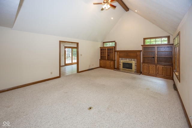 1112 N Dogwood Way, Greenfield, IN 46140 - unfurnished living room with a ceiling fan, light colored carpet, healthy amount of natural light, a glass covered fireplace, and high vaulted ceiling