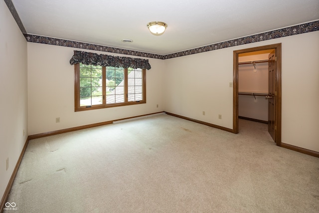1112 N Dogwood Way, Greenfield, IN 46140 - unfurnished bedroom featuring light colored carpet, a baseboard radiator, a walk in closet, and a closet