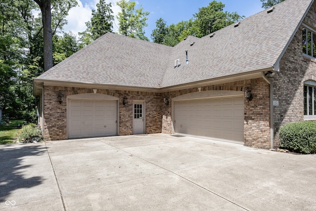 1112 N Dogwood Way, Greenfield, IN 46140 - view of front facade with a shingled roof, brick siding, and concrete driveway