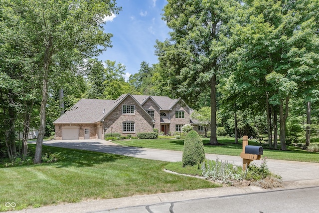 1112 N Dogwood Way, Greenfield, IN 46140 - view of front of property with stone siding, driveway, an attached garage, and a front yard