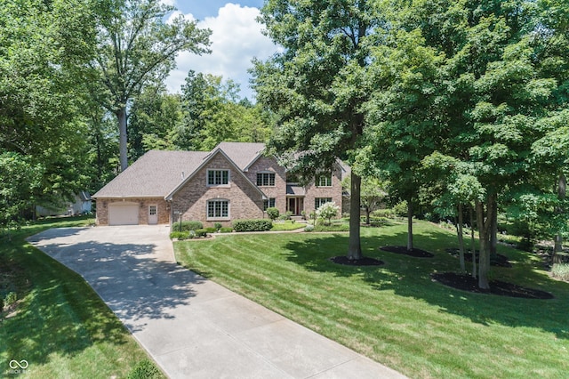 1112 N Dogwood Way, Greenfield, IN 46140 - view of front of home with driveway, a front yard, brick siding, and a garage