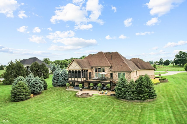 3075 Hurricane Rd, Franklin, IN 46131 - rear view of house with a fire pit, a sunroom, a wooden deck, a yard, and a patio area