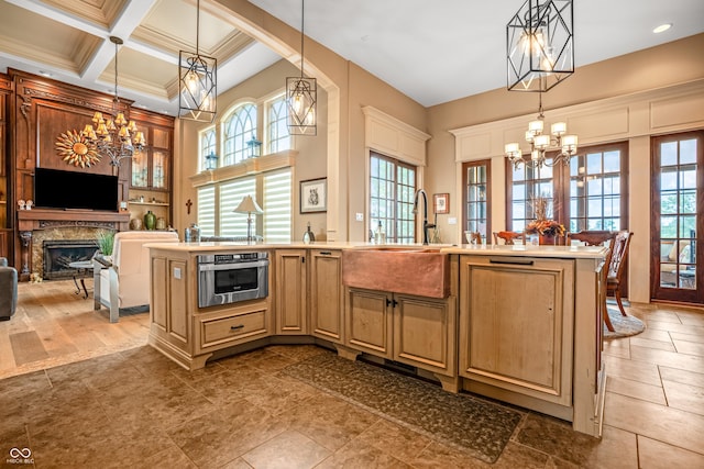3075 Hurricane Rd, Franklin, IN 46131 - kitchen with a chandelier, light countertops, a premium fireplace, stainless steel oven, and plenty of natural light